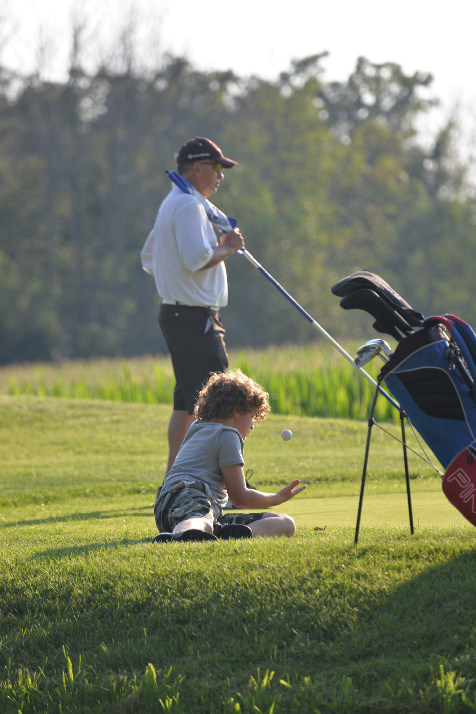 Caddying with his grandson patiently waiting.